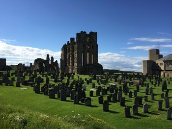 High angle view of cemetery by old ruins against sky