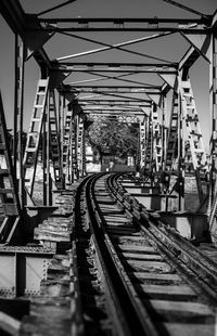 Railroad tracks in bridge against sky