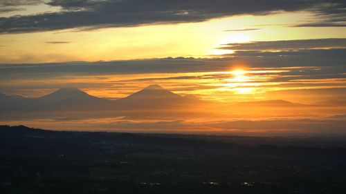 Scenic view of sunset over mountain