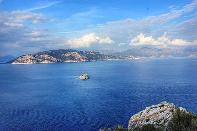 Scenic view of sea against cloudy sky
