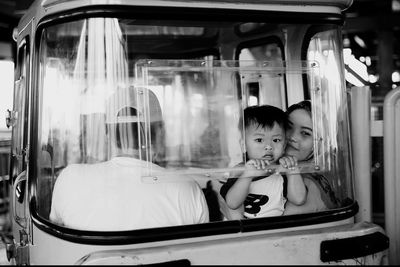 Portrait of cute boy looking through carousel window