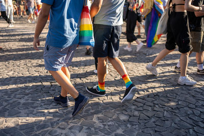 Low section of people walking on street