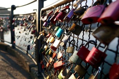 Padlocks hanging on railing