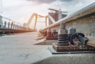 Close-up of rusty bridge against sky