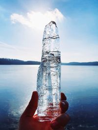 Person holding ice against sky