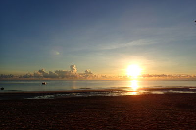 Scenic view of beach against sky during sunset