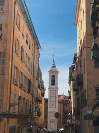 Low angle view of buildings in city against sky