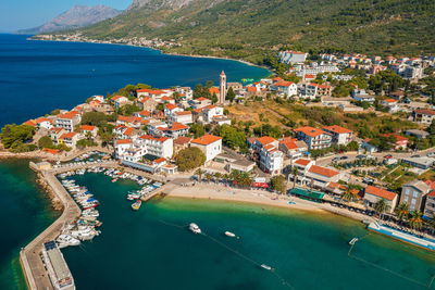 Aerial view of gradac town below biokovo mountain, the adriatic sea, croatia