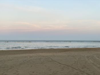 Scenic view of beach against sky during sunset