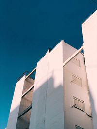 Low angle view of building against clear blue sky