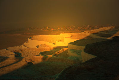 High angle view of field against sky during sunset