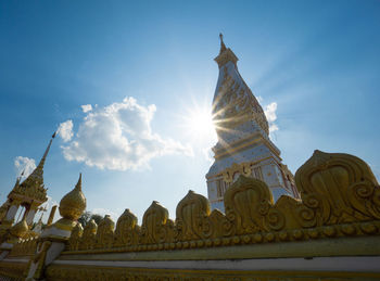 The pagoda of wat phra that panom temple in nakhon phanom in cloudy blue sky day with sunlight