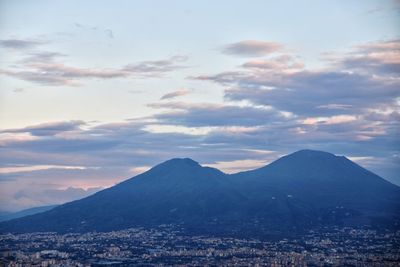 Aerial view of city and mountains against sky