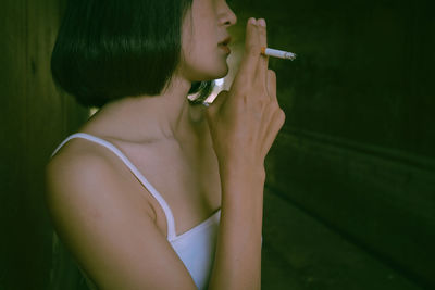 Midsection of woman holding cigarette