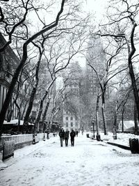 People walking on snow covered landscape