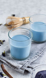 High angle view of blue drink in glasses on table