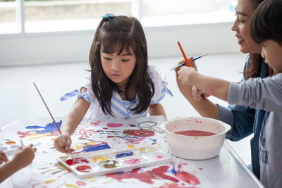 Kids painting on paper