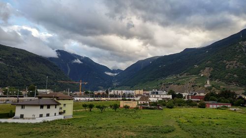 Scenic view of buildings and mountains against sky