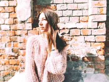 Woman standing against wall