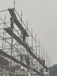 Low angle view of crane against clear sky