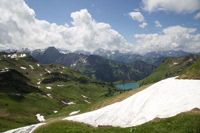 Scenic view of mountains against cloudy sky