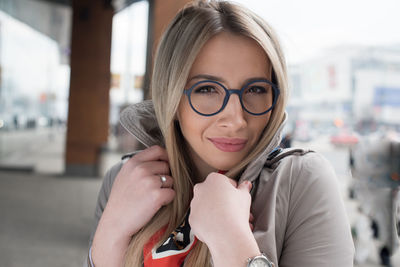 Portrait of smiling young woman in city