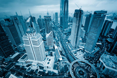 Aerial view of modern buildings in city against sky