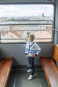 Rear view of boy looking at camera