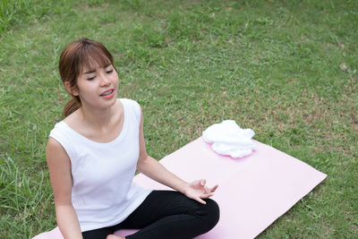 High angle view of woman sitting on field