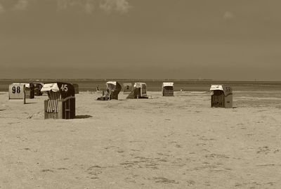 People on beach against sky