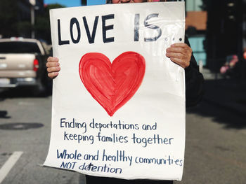 Close-up of heart shape with text on street