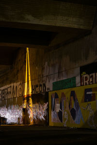 Low angle view of illuminated text on building at night
