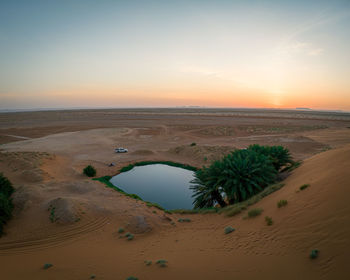 Scenic view of desert against sky during sunset