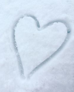 Close-up of heart shape on snow