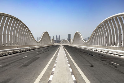 An empty road on a meydan bridge with city view on background in dubai