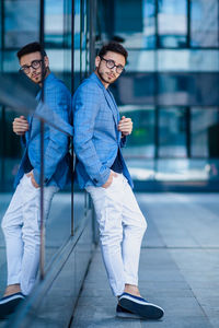 Side view portrait of businessman leaning on modern building