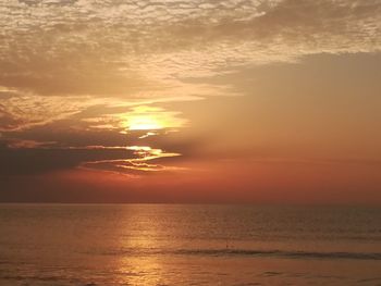 Scenic view of sea against orange sky