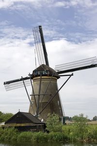 Low angle view of windmill against sky