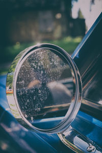 Close-up of reflection on side-view mirror of car