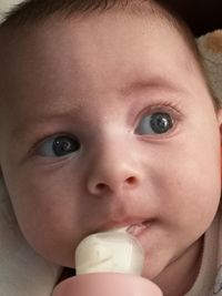 Close-up portrait of cute boy drinking