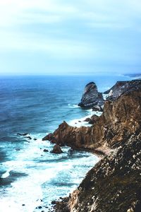 Scenic view of sea and rocks against sky