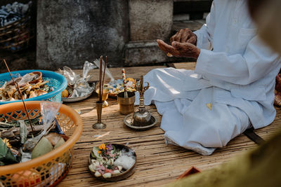 Midsection of man preparing for pray at the temple on bali