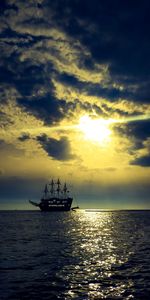Silhouette boat sailing on sea against sky during sunset