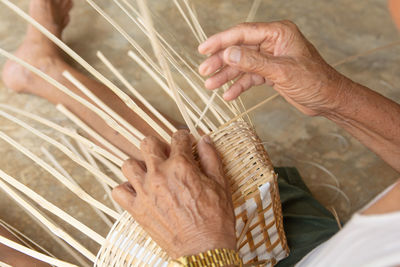 High angle view of man preparing food in basket