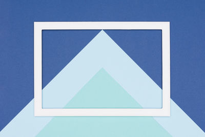 High angle view of white paper against blue background