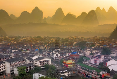 High angle shot of townscape against sky during sunset