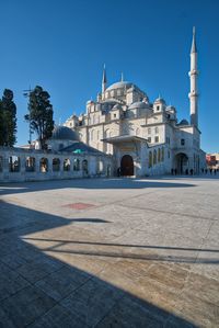 View of mosque against clear blue sky