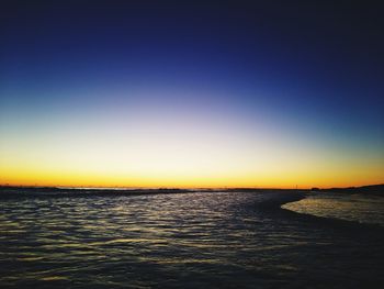 Scenic view of sea against clear sky during sunset