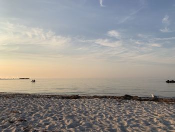 Scenic view of beach against sky during sunset