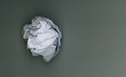 Close-up of crumpled paper against gray background